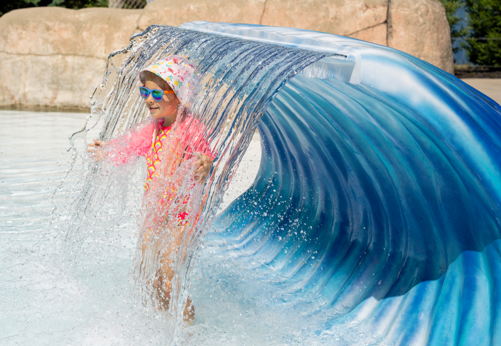 child playing with water feature