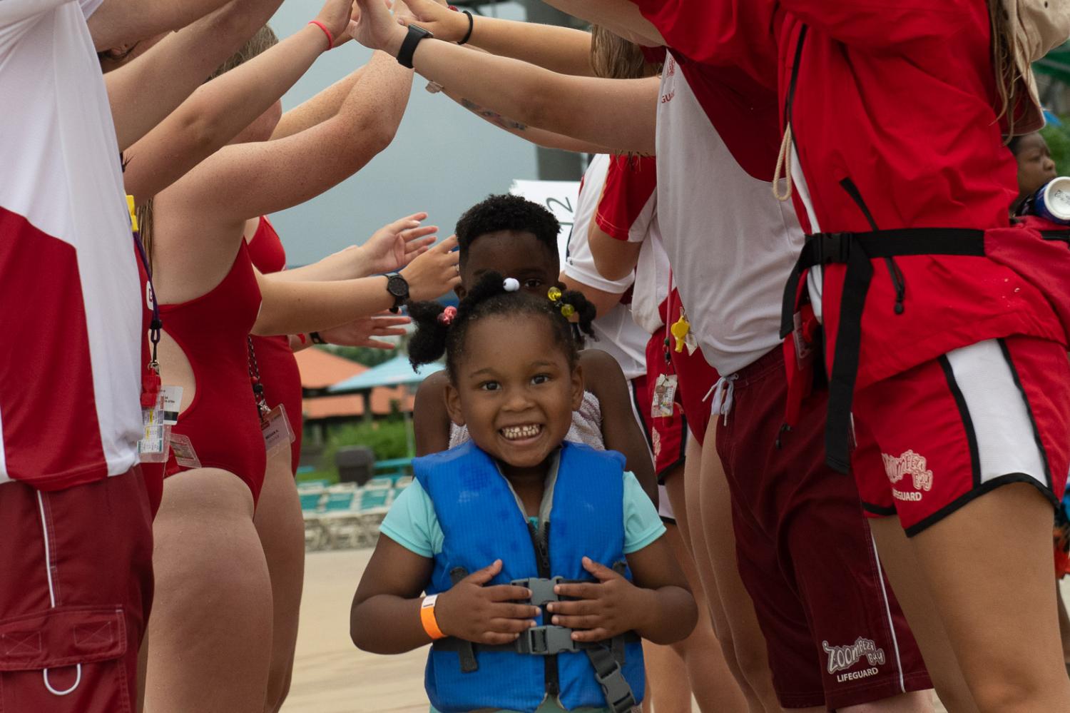 child smiling while wearing lifejacket