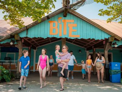 family walking in front of restaurant