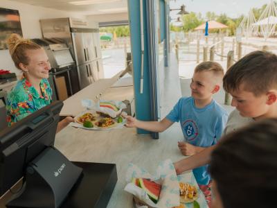 kids taking tacos from employee