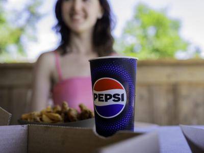 pepsi cup with water park guest in background
