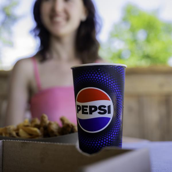 pepsi cup with water park guest in background