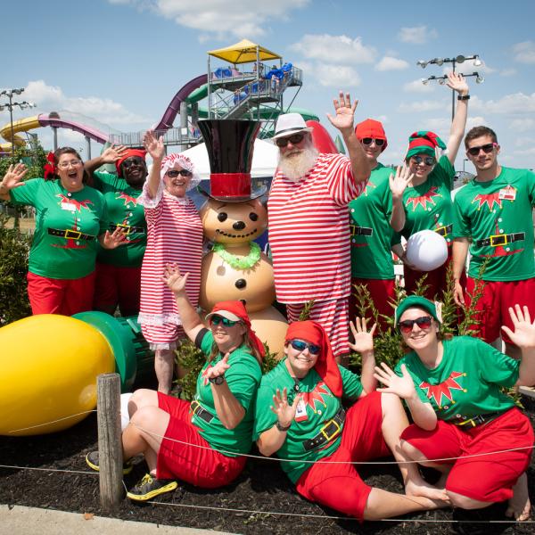Santa, Mrs. Claus, and Elves Smile for the Camera